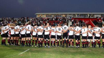 The Arabian Gulf rugby team stand for the UAE national anthem ahead of their Asian Five Nations match against Korea at The Sevens rugby grounds in Dubai yesterday.
