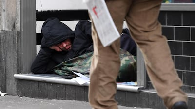 A homeless man sleeps in a door way in London. EPA