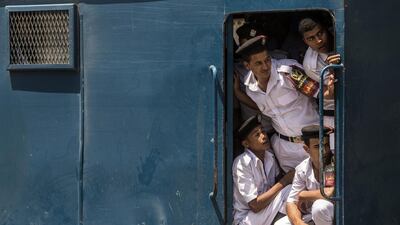 Egyptian policemen lookout from a parked vehicle as they wait for the arrival of the body of Nobel Prize-winning Egyptian-American chemist Ahmed Zewail at Cairo airport. Khaled Desouki / AFP Photo