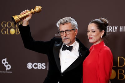 Brazilian film director Kleber Mendonca Filho, left, and French film producer Emilie Lesclaux pose with the award for Best Motion Picture - Non-English Language for The Secret Agent. EPA