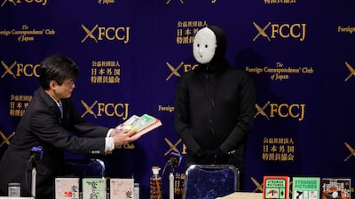 Japanese horror writer, novelist, and YouTuber Uketsu, right, attends a press conference at the Foreign Correspondents' Club of Japan in Tokyo. Uketsu, one of Japan's most widely read authors, remains an enigmatic figure behind a white mask, and no one knows his true identity. EPA