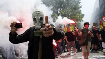 A protester wearing a gas mask during a demonstration by striking employees of the French state rail company SNCF protesting a government railway reform project. Bertrand Guay / AFP