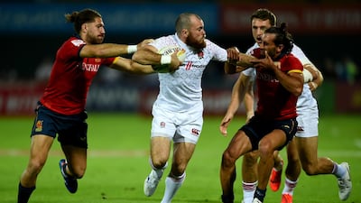 Tom Bowen of England tackles Spain players at The Sevens Stadium in Dubai. Getty Images