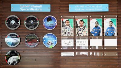 Photos of UAE astronauts and badges of space missions hang on the wall inside the Mohammed bin Rashid Space Centre.