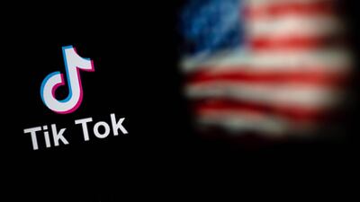 This photo illustration taken on September 14, 2020 shows the logo of the social network application TikTok and a US flag. The Trump administration is reviewing a proposal from TikTok parent ByteDance and Oracle that aims to avert an outright sale of the app or a shutdown of its US operations set to take effect September 20. AFP