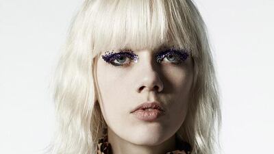 Shimmering eye make-up is teamed with a velvet cape featuring a heavy gold fastening and a ruffled neck, leopard print blouse. Courtesy Saint Laurent