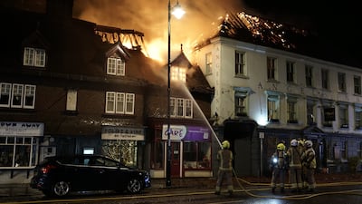 Firefighters tackle a fire in Midhurst, West Sussex, which engulfed buildings, including a 400-year-old hotel that was said to be housing Ukrainian refugees. PA