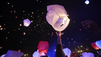 Croatia: A participant holds up a sky lantern to be released during the "Kapulica & Lanterns" event, part of the ArtOmat Fair ahead of Christmas, involves people releasing about a thousand lanterns to symbolize sending own wishes to the universe. Reuters/Antonio Bronic