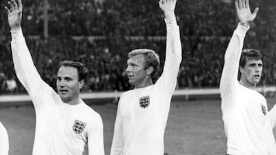 England's captain Bobby Moore, centre, with teammates George Cohen, left, and Geoff Hurst as they wave to the crowd during the 1966 World Cup at Wembley. AP