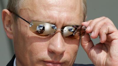 Putin adjusts his sunglasses during the MAKS-2005 International air and space show in Zhukovsky on August 16, 2005. AFP