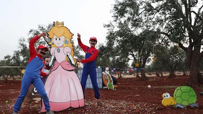 Children play on Eid Al Fitr at a displaced persons camp in the village of Killi in Syria's rebel-held north-western city of Idlib. AFP