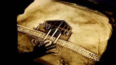 Shayma Ahmed Al Mughairy during her sand art performance at the Ramadan tent in the Emirates Centre for Strategic Studies and Research office in Abu Dhabi. Pawan Singh / The National