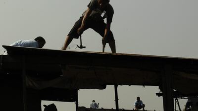 Filipino members of a demolition team tear down houses during an eviction of illegal settlers in Manila, Philippines. Around 500 families were affected as the government plans to expand a major thoroughfare according to the official of an urban poor group. Francis R. Malasig / EPA