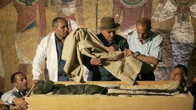 Zahi Hawass, centre, supervises the removal of the mummy of King Tutankhamun from his stone sarcophagus in his underground tomb in the Valley of the Kings. Ben Curtis / Pool / AP Photo