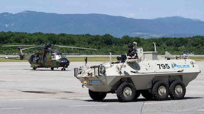 A French military helicopter and an armoured vehicle belonging to Geneva police provide security at Geneva airport. AFP
