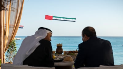 A microlight flies the UAE flag during a meeting between Sheikh Mohamed and Mr El Sisi