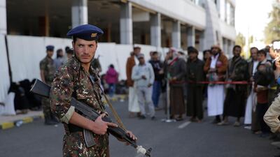 A soldier stands guard at the airport during the arrival of Houthi prisoners released by the Saudi-led coalition, in Sanaa, Yemen, on November 28, 2019. AP