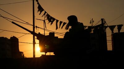 A silhouetted Lebanese soldier sits on his armoured personnel carrier at the entrance of Burj Al Barajneh Palestinian refugee camp. AP