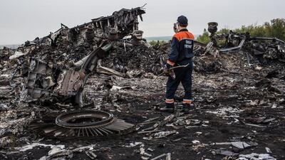An emergency services worker photographs debris of the Malaysian Airlines plane that crashed in eastern Ukraine. Photo: Brendan Hoffman / Getty Images