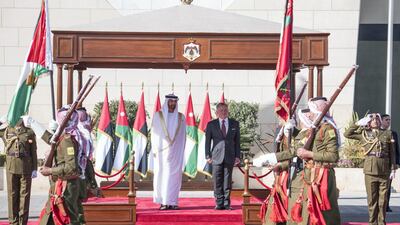 Sheikh Mohamed bin Zayed and King Abdullah stand for a National Anthem. Hamad Al Kaabi / Ministry of Presidential Affairs