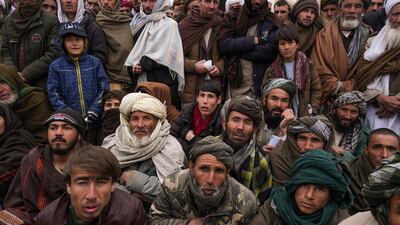 Hundreds of Afghan men gather to apply for humanitarian aid in Qala-e-Naw, Afghanistan, on December 14, 2021. AP