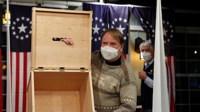 A poll worker shows an empty box for ballots for the U.S. presidential election at the Hale House at Balsams Hotel in the hamlet of Dixville Notch, New Hampshire. Reuters