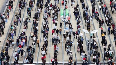 People queue outside a mass vaccination centre for those aged 18 and over at the London Stadium. Reuters