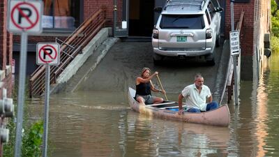 Jodi Kelly, left, practice manager at the flooded Stonecliff Veterinary Surgical Centre in Vermont, and her husband, veterinarian Dan Kelly, move supplies. AP