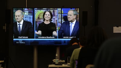 Journalists in a nearby room watch as the candidates debate in Berlin. Photo: Getty