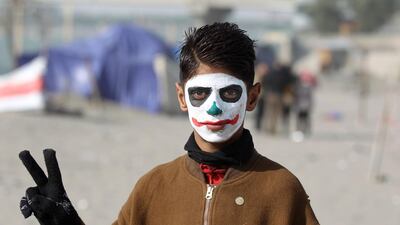 An Iraqi protester wearing face-paint imitating DC comic and film character "The Joker" . AFP