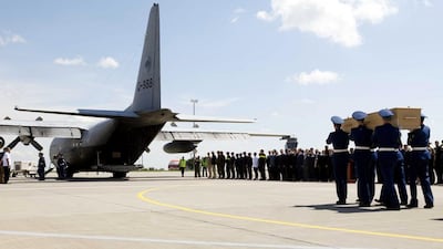 Soldiers carry a coffin with the remains of a victim of Malaysia Airlines flight MH17 to a military plane during a ceremony in the airport of Kharkiv, Ukraine, 23 July 2014. A Dutch transport aircraft with 14 coffins leaves the eastern Ukrainian city of Kharkiv, transporting the first victims of the downing of Malaysia Airlines flight MH17 to the Netherlands. Evert-Jan Daniels/EPA