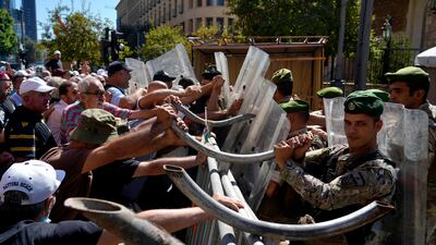 Soldiers scuffle with retired army members as they try to enter to the parliament building while the legislature was in session discussing the 2022 budget in Beirut, Lebanon this week. AP