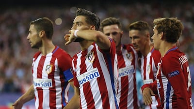 Atletico Madrid’s Yannick Carrasco celebrates with teammates after scoring the first and winning goal against Bayern Munich. Daniel Ochoa de Olza / AP Photo