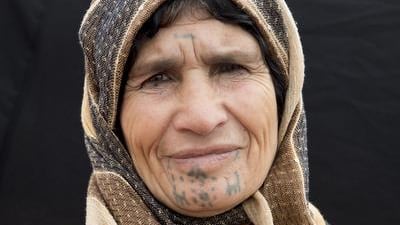 Amina Saleh, 60 year-old woman from Musko, a village of Kobani. Mother of six, she had her face tattooed when she was about 10 years old.