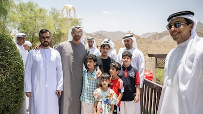 The President, Sheikh Mohamed, stands for a photograph with an Emirati family during a tour of the Northern Emirates. Seen with Sheikh Mansour bin Zayed, Deputy Prime Minister and Minister of Presidential Affairs. Hamad Al Kaabi / Ministry of Presidential Affairs