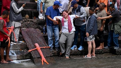 Relatives mourn at symbolic funerals held for people still missing after the floods, as effigies are cremated in accordance with Nepali Hindu rites, at a temple in Kathmandu. AFP