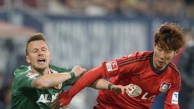 Leverkusen's Korean striker Son Heung-Min, right, and Augsburg defender Ronny Philp vie for the ball during their Bundesliga match on Wednesday. Christof Stache / AFP / March 26, 2014
