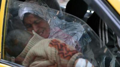 The Assad regime hit back against rebels by shelling the capital yesterday. In Aleppo, a woman cries holding her injured son in a taxi as they arrive at a hospital following shelling by government forces. Fighting was also reported in Safireh in the north.