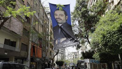 A portrait of Lebanese Prime Minister Saad Hariri hangs above a crowded street in central Beirut on May 4, 2018, ahead of Sunday's first legislative elections in nine years. Joseph Eid / AFP Photo