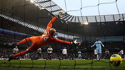 Brad Friedel of Tottenham Hotspur is unable to stop Mario Balotelli's late penalty.