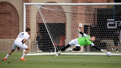 Goalkeeper Andriy Lunin attempts a save during training in Los Angeles. EPA