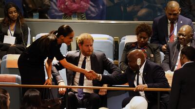 Prince Harry and his wife Meghan greet Guinea’s Foreign Minister Morissanda Kouate. AFP