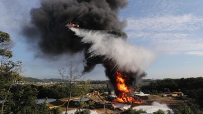 A firefighting helicopter tries to extinguish flames engulfing a large oil storage tank in Goyang, northwest of Seoul, South Korea. EPA