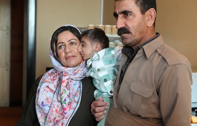 Afshin Ghaderzadeh is embraced by his parents. Pawan Singh / The National