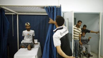 Palestinian Mohammed Abed Al Dayem, 25, waits to undergo physiotherapy at an artificial limbs centre in Gaza City.