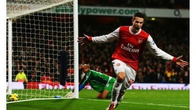 Robin van Persie wheels away after completing his hat-trick against Wigan yesterday. The strikes took the Arsenal striker's tally to six goals in six league starts this season. Mike Hewitt / Getty Images