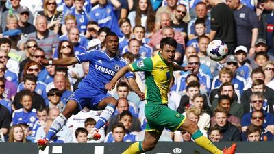 Chelsea's Ashley Cole, left, challenges Norwich City's Russell Martin during their English Premier League match at Stamford Bridge in London on May 4, 2014. Eddie Keogh / Reuters