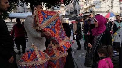 A woman and her daughter shop for a traditional lantern. AP Photo