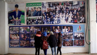 Jiu Jitsu club members look at a wall with posters at their club ahead of a training session in Kabul, Afghanistan. AP