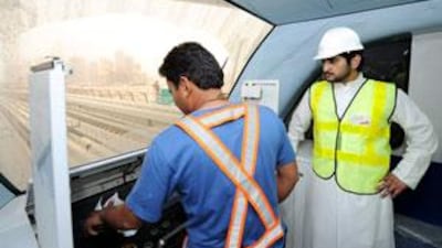 Sheikh Maktoum bin Mohammed, Deputy Ruler of Dubai, watches a Metro driver at work during inspection of the system.